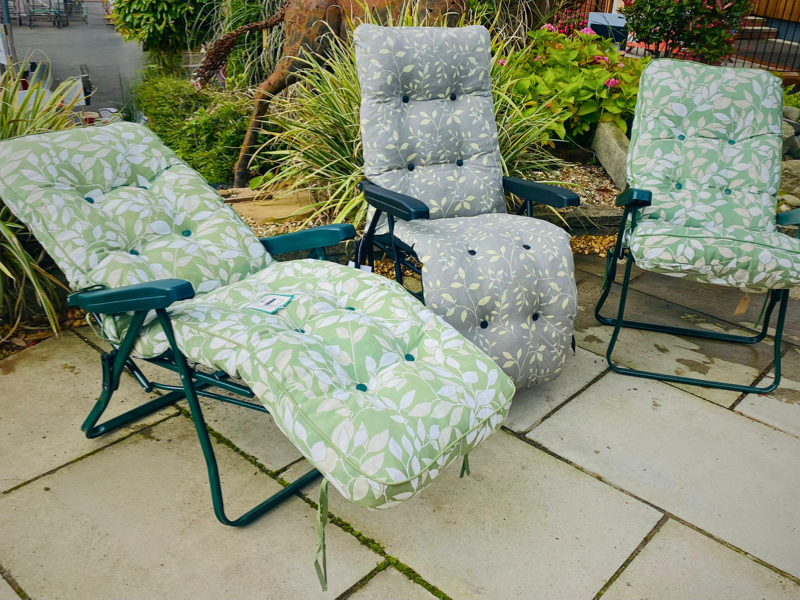 3 green sun loungers with a tropical leaf print