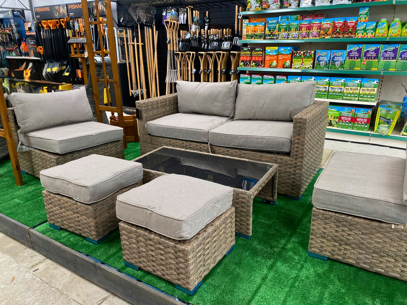 A six-seater garden set made out of rattan, with a glass coffee table.
