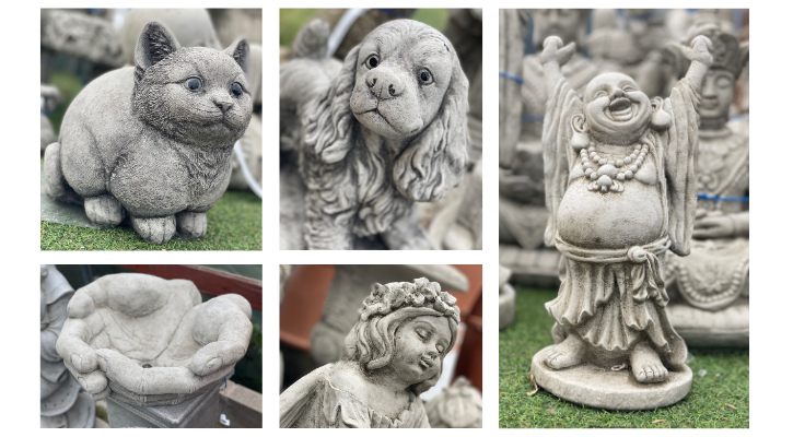 A selection of stoneware featuring a cat, spaniel, hands, an angel and a Buddha.
