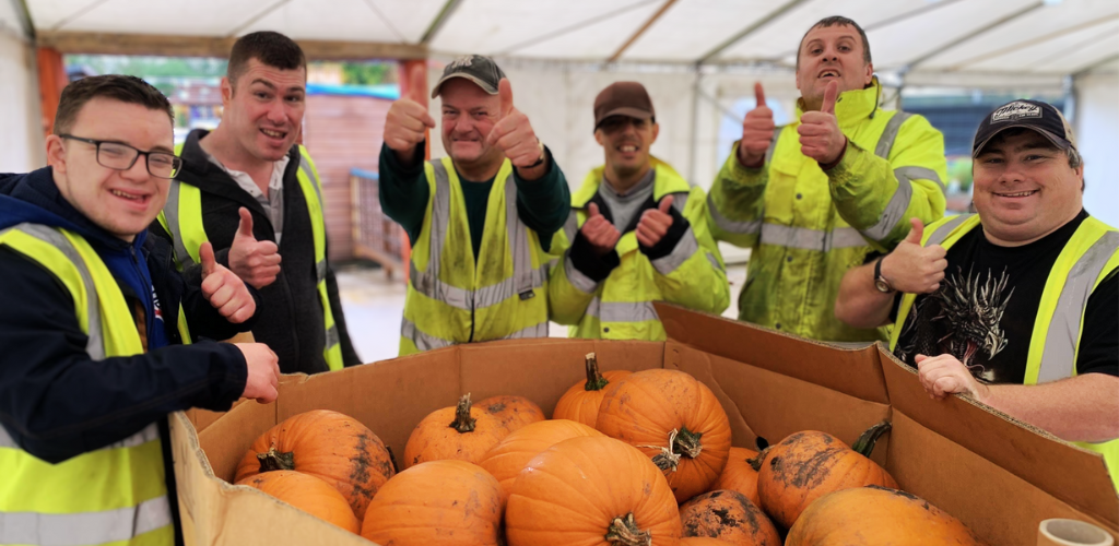 Students unloading a big pallet of pumpkins for Halloween